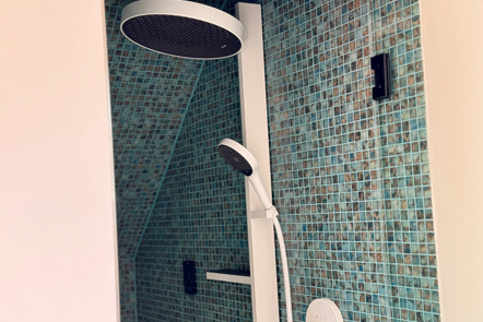 Image of shower head in tiled bathroom